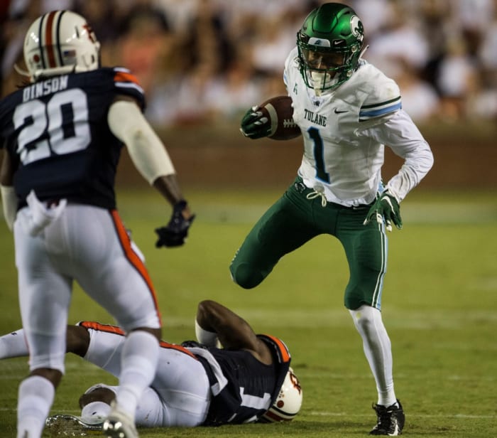 Former Tulane wide receiver Jalen McCleskey (1) hurdles Auburn defensive back Javaris Davis (13) © Jake Crandall, Montgomery Advertiser via Imagn Content Services, LLC